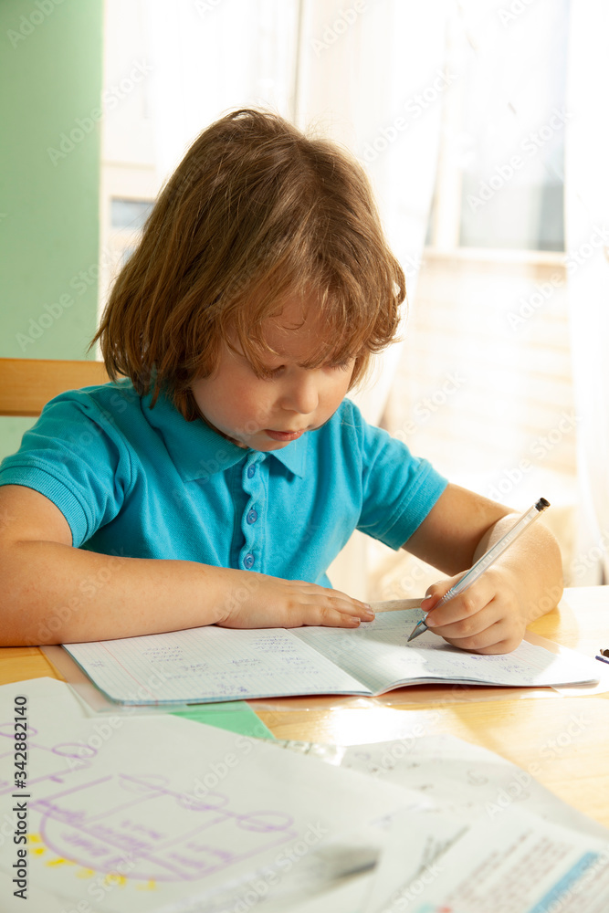boy is doing his homework at home during a pandemic boy is doing his homework at home during a pandemic
