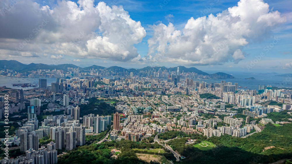 Wide angle aerial view of densely populated Kowloon City of Hong Kong from Lion Rock on a bright sunny dayS