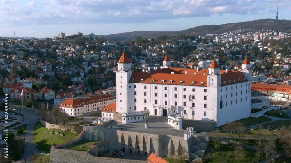 Aerial of Bratislava Castle, Slovakia - Cinematic Pan Shot of Medieval Fairytale Bratislava Castle With Ancient Walls and Slovak Flag During an Autumn Evening