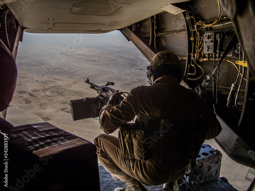 Helmand, Afghanistan - January 2013: Ramp gunner on a US MArines Osprey flying over Helmand