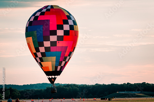 Hot air balloon floating by during a beautiful sunset in Battle Creek Michigan photo