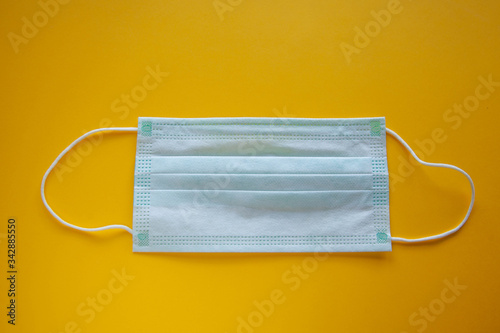 Coronavirus or covid19 microbe protection mask and gloves or hand sanitizer for hand washing, fever monitor for doctors and hospital in isolated on yellow background.