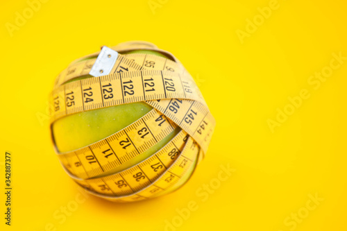 Green apples measured the meter. Healthy food for weight loss.