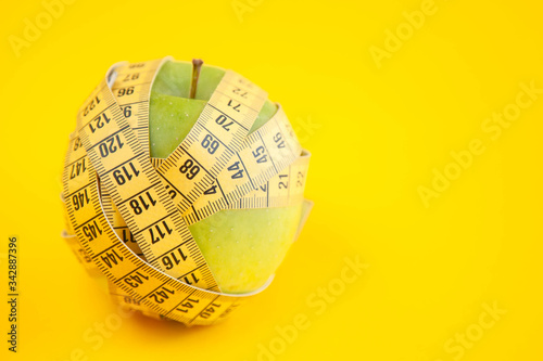 Green apples measured the meter. Healthy food for weight loss.