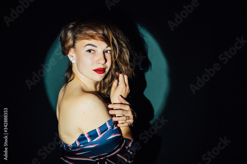 very beautiful girl posing with her back to the camera on a green background photo