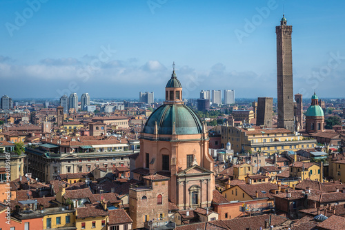 Old town of Bologna city, Italy seen from terrace of St Petronius basilica, view with Two Towers and dome of Santa Maria della Vita church