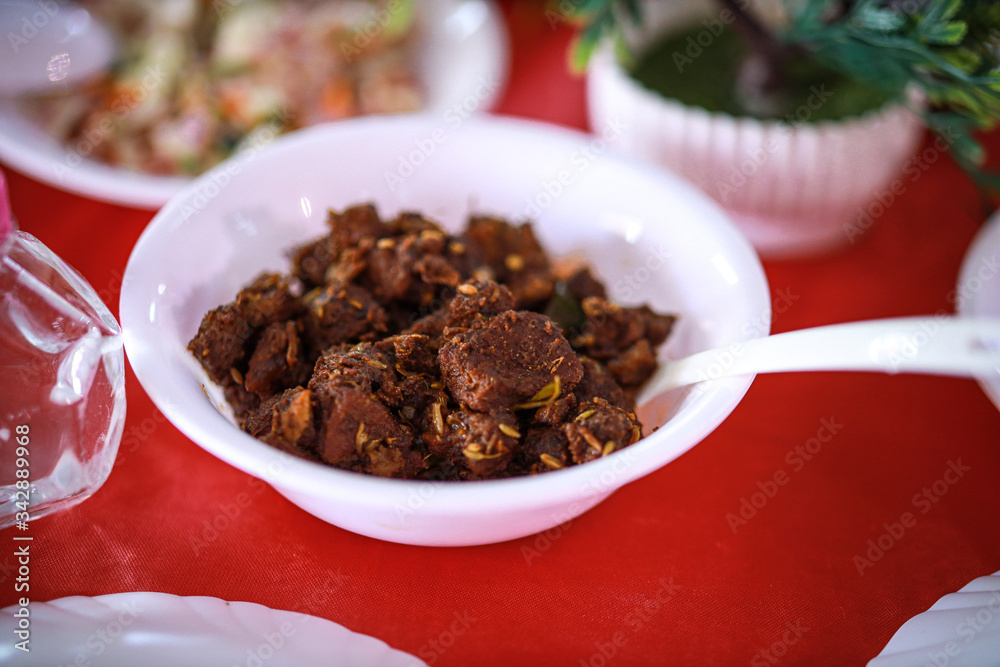 Kerala style beef dry fry. delicious spicy Beef fry in banquet table with chafing dish heaters. It goes well with ghee rice, kappa,appam, parotta, puttu, Kerala style cuisine ,beef roast.India Kerala style beef dry fry. delicious spicy Beef fry in banquet table with chafing dish heaters. It goes well with ghee rice, kappa,appam, parotta, puttu, Kerala style cuisine ,beef roast.India