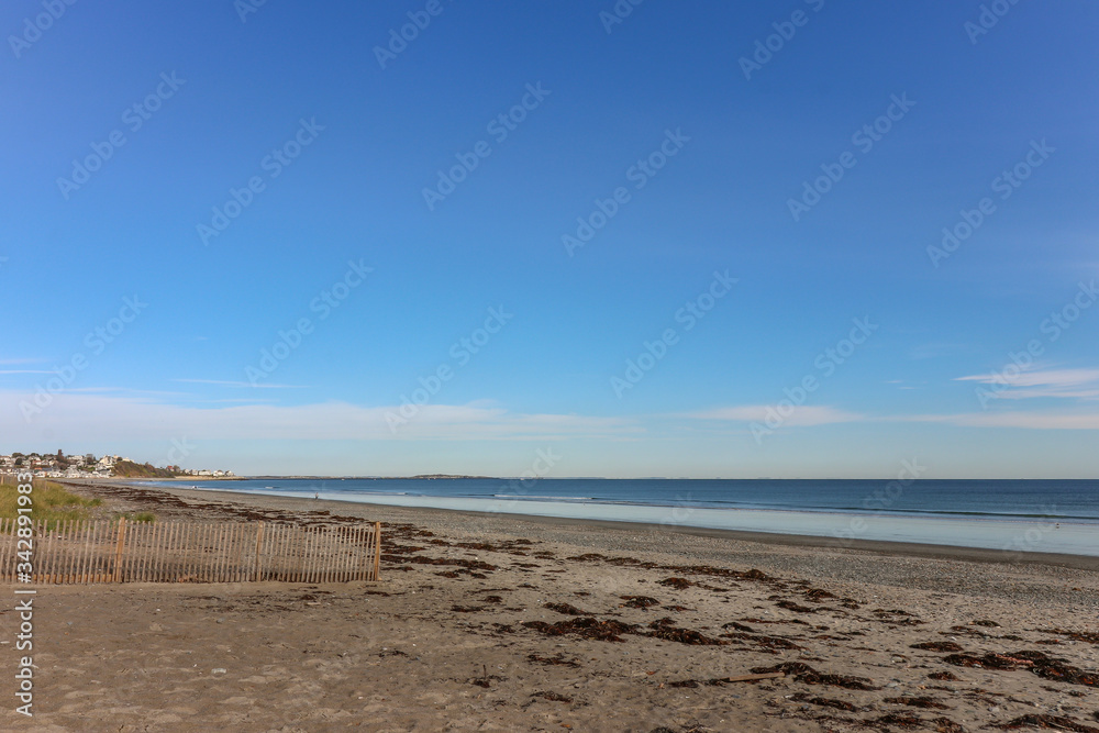 seascape of dirty beach with seaweed and ocean and sky in background seascape of dirty beach with seaweed and ocean and sky in background