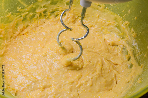 Electric mixer in a plate whips the dough