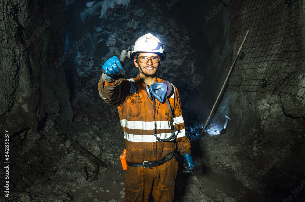 miner-in-the-mine-well-uniformed-miner-inside-mine-raising-thumb