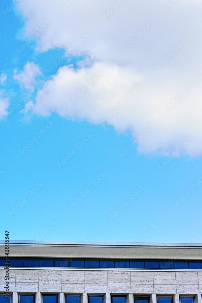 building roof and blue sky white clouds over architecture. Front view of Architecture blue sky and white clouds, 