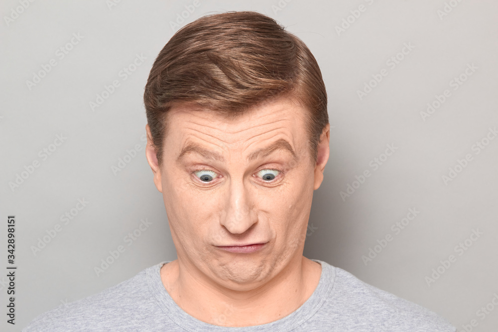 Portrait of blond mature man with fool goofy perplexed expression Portrait of blond mature man with fool goofy perplexed expression