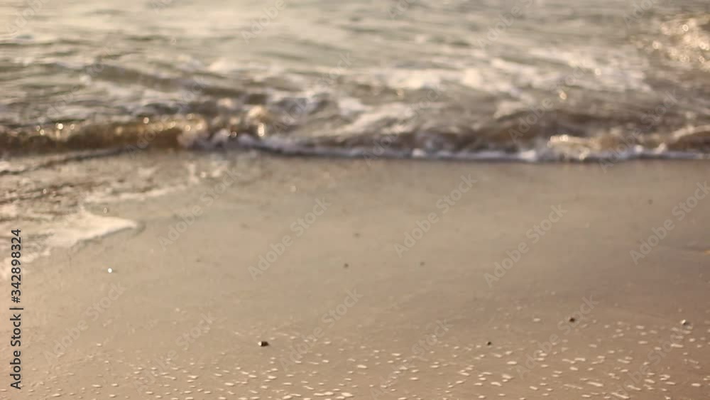 ocean waves roll onto the sandy shore