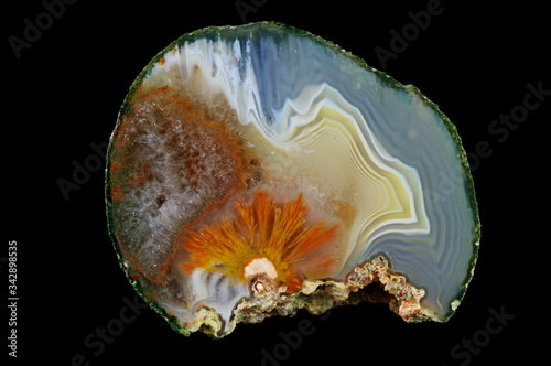 Sagenite - fortress agate with quartz geode. Colorful ribbons colored with metal oxides are visible. Origin: Rudno near Krakow, Poland.
