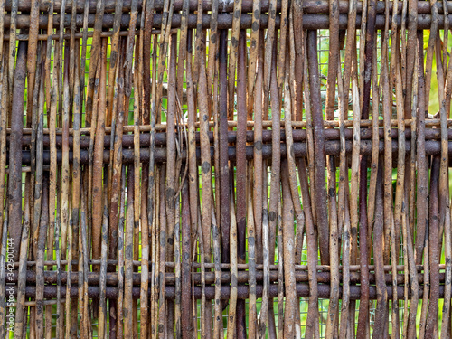 Wood twig wattle fence detail. Rustic background.