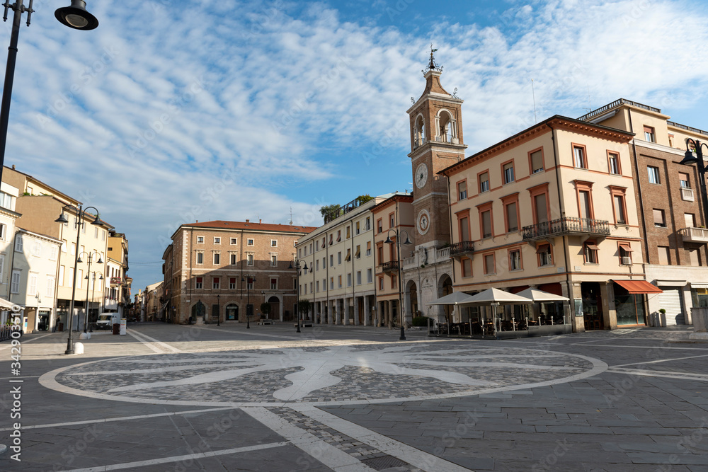 Rimini, Emilia-Romagna/ Italy-May 31, 2019: Empty central square of Rimini, Italy. The area of the Three Martyrs with an ancient clock tower.