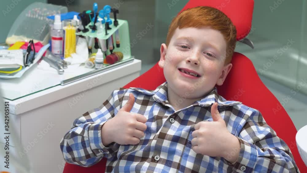 Little boy at the dentist, close-up of little boy showing thumb up. Pediatric dentistry Little boy at the dentist, close-up of little boy showing thumb up. Pediatric dentistry