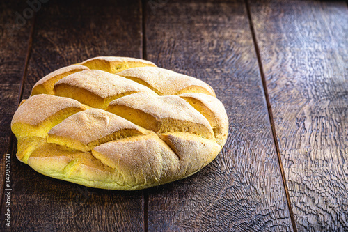 homemade corn bread made in brazil, organic and without preservatives. natural product, rustic wood background. photo