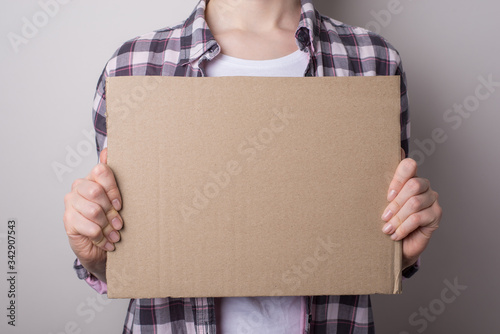 Recruitment concept. Cropped close up photo of desperate disappointed female businesswoman holding showing carton placard with copy space