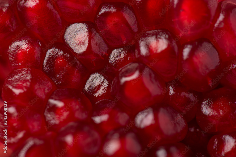 Closeup cropped view macro photo of red juicy fresh pomegranate seeds texture Closeup cropped view macro photo of red juicy fresh pomegranate seeds texture