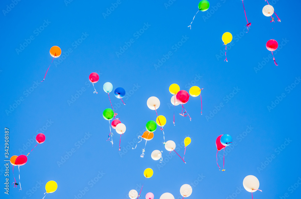 colorful balloons flying in the blue sky colorful balloons flying in the blue sky