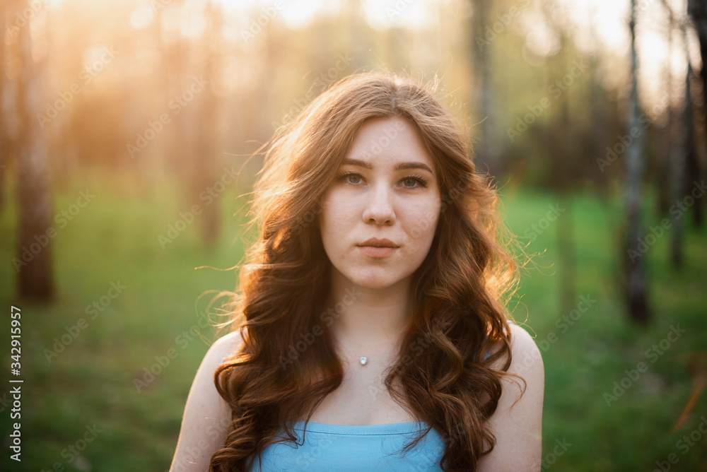 Beautiful young girl in a blue dress in a spring park Beautiful young girl in a blue dress in a spring park