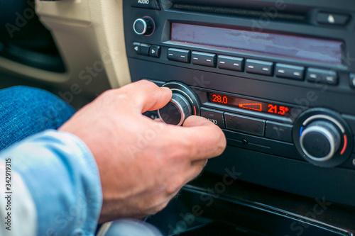 Close hand a man pressing switch air on Power switch of a Car air conditioning system control