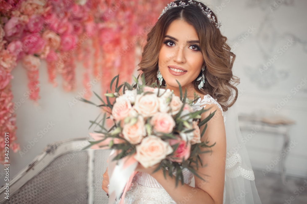 A bride of Eastern appearance in a white wedding dress. A bride of Eastern appearance in a white wedding dress.