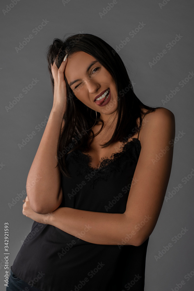 Girl posing in studio on grey background. Isolated Girl posing in studio on grey background. Isolated