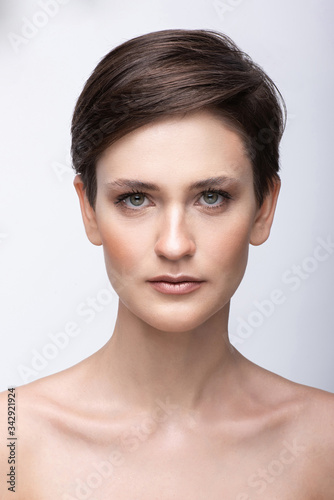 Portrait of a young girl with a long neck, almost no makeup on her face, photo without retouching, natural makeup and vivid emotions, smile and joy in the look
