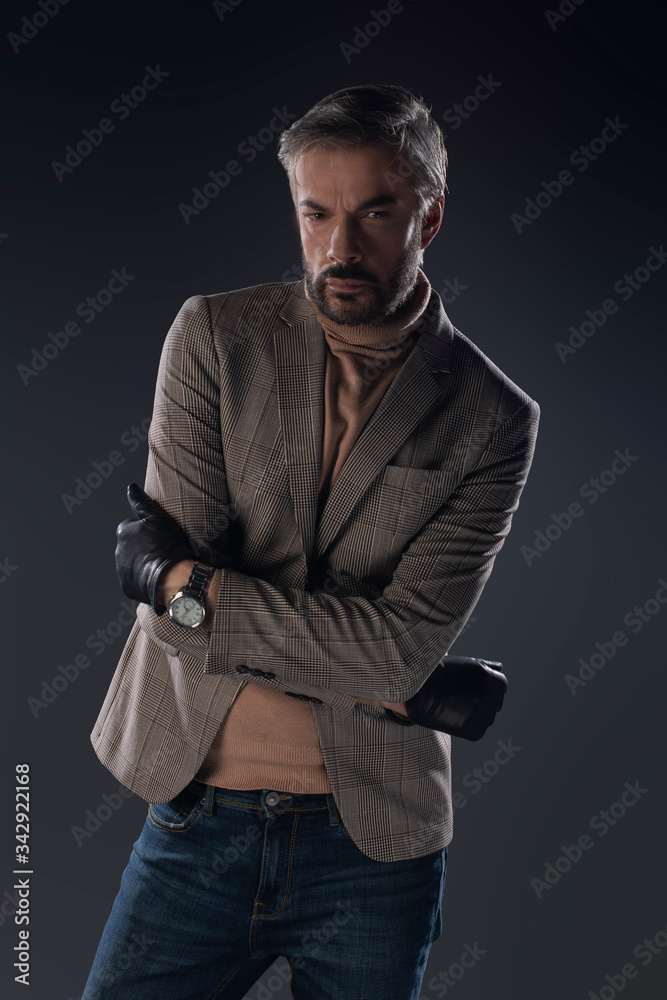 Fototapeta premium Male model posing in studio on grey background. Isolated