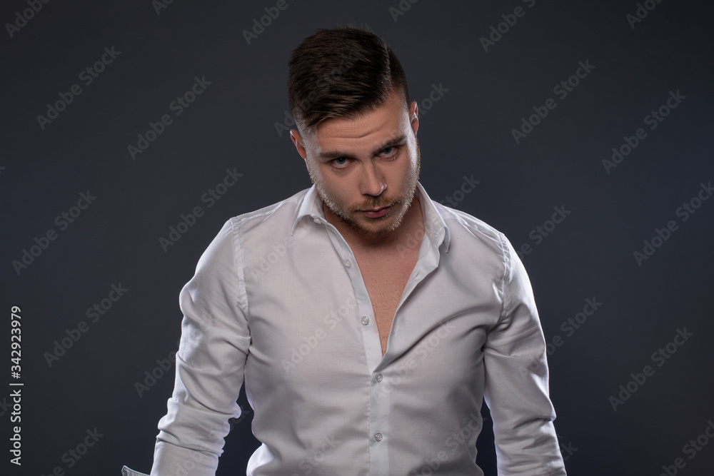 Portrait of beautiful man on grey background. Studio Isolated Portrait of beautiful man on grey background. Studio Isolated
