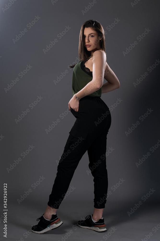 Portrait of girl posing in studio on grey background. Isolated Portrait of girl posing in studio on grey background. Isolated