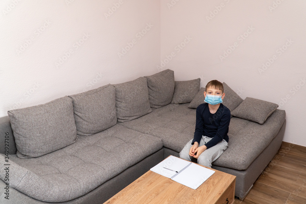 Isolated child Quarantined at Home in mask, Coronavirus Epidemic. Distance education and learning. Self isolation, home quarantine. World Crisis COVID-19. Distance learning at home. Space for text