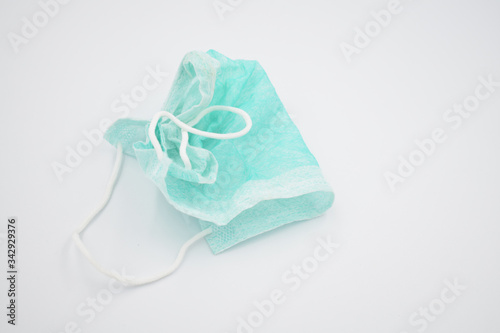 Used surgical face mask, corona virus protection mask isolated on a white background