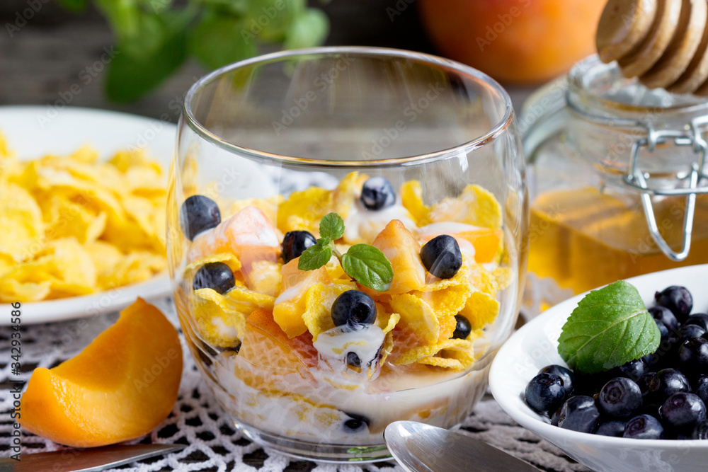 Cornflakes with yogurt, honey and fruits. Cornflakes with yogurt, honey and fruits.