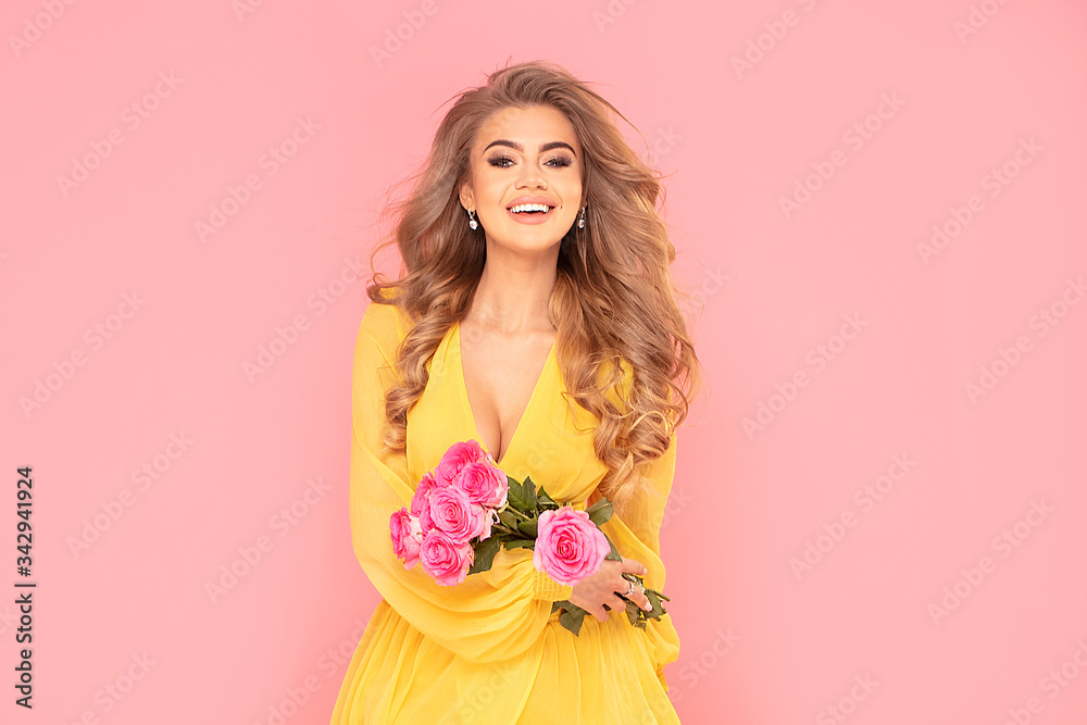 Smiling blonde woman holding spring flowers. Smiling blonde woman holding spring flowers.