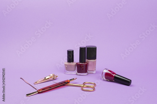 Set for care of nails on a violet background.