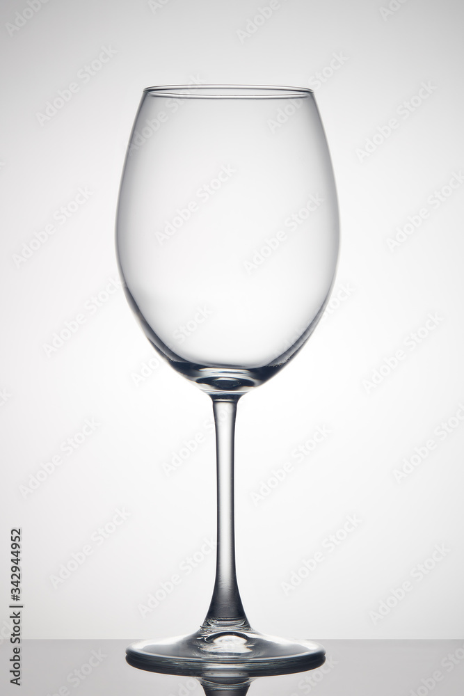 Empty glass for wine on gray background. Wineglass Empty glass for wine on gray background. Wineglass
