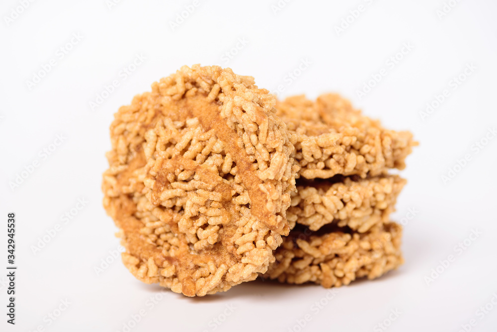 Stack of sweet crispy rice with cane sugar drizzle isolated on white background, Local Thai snack (Khao Tan) Stack of sweet crispy rice with cane sugar drizzle isolated on white background, Local Thai snack (Khao Tan)