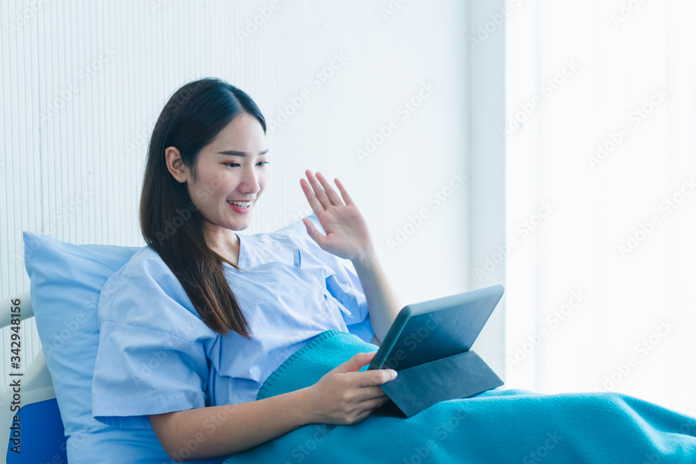 Asian female patients are greeting friends and family via almost the online network while quarantining the corona virus outbreak. Covid19 Asian female patients are greeting friends and family via almost the online network while quarantining the corona virus outbreak. Covid19