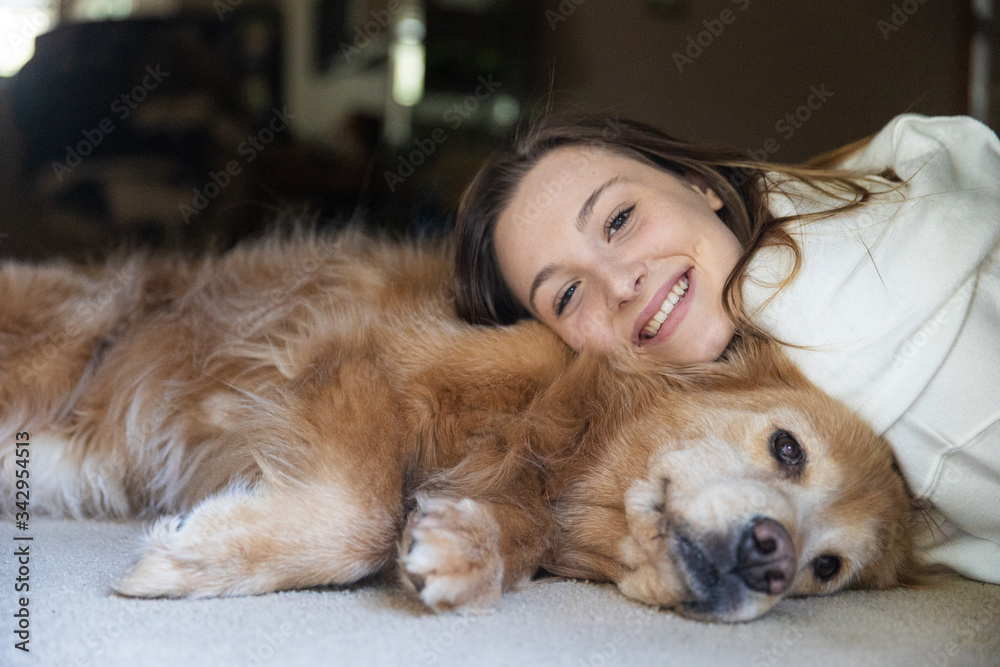 Teenage girl taking a nap on the floor with her golden retriever dog Teenage girl taking a nap on the floor with her golden retriever dog