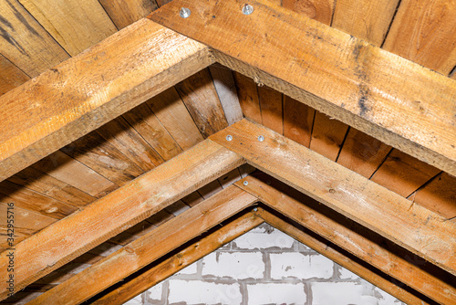 Roof made of rafter-type roof truss, close-up view from the inside, wooden roof.