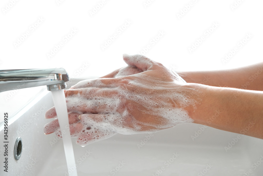 Fototapeta premium hand of beauty woman wash your hands at the wash basin with foam, cleanse the skin and have water flowing through the hands. Health and beauty concepts