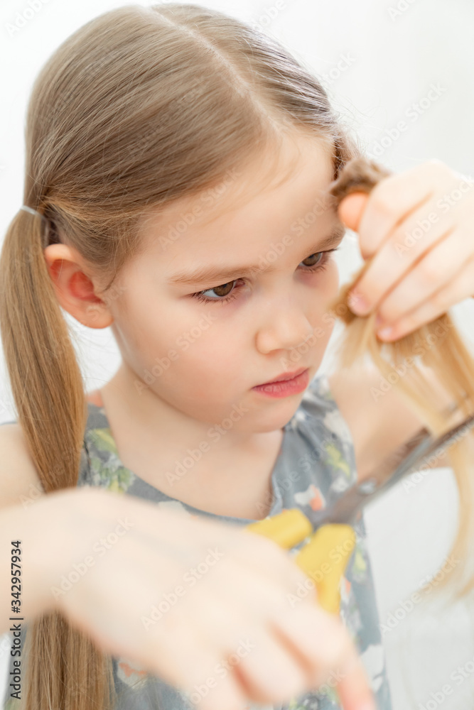 little girl cutting hair to herself with scissors little girl cutting hair to herself with scissors