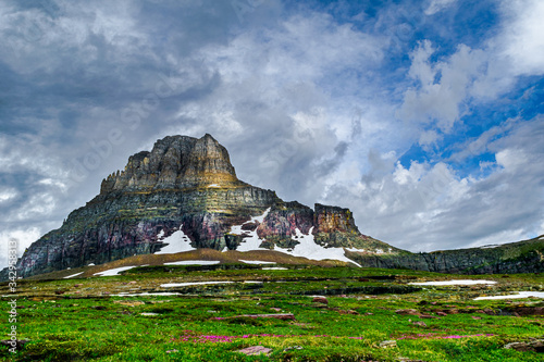 0000265_A meadow of wildflowers carpets the foreground leading to Clements Mountain as a storm brews at Logan Pass, Glacier National Park – Montana_ 4820