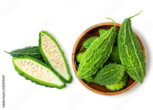 Photography Closeup fresh bitter gourd ( cucumber, Momordica Charantia) in wooden bowl isolated on white background