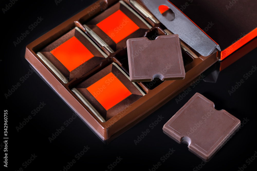 Premium chocolate ads. Chocolate bars in box on black background. Premium chocolate ads. Chocolate bars in box on black background.