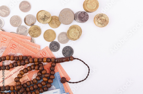 Rosary, banknotes and coins, islamic banking/finance concept. photo