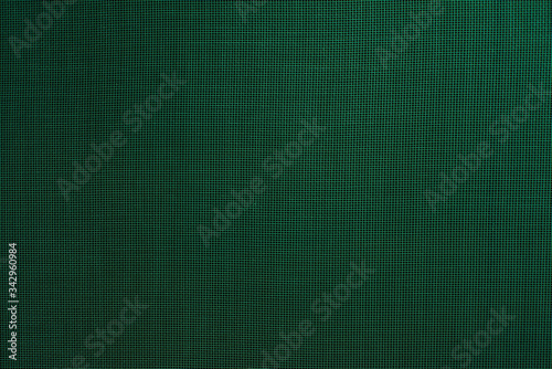 dark abstract background: unique wavy pattern of overlaying two grids, blurry and tinted green